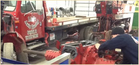 A man working on automotive engine