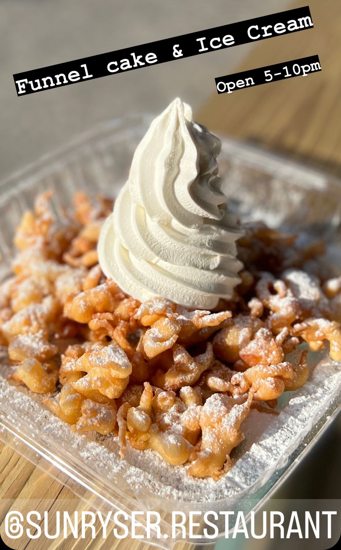 Funnel cake with vanilla soft-serve dusted with powdered sugar on a tray