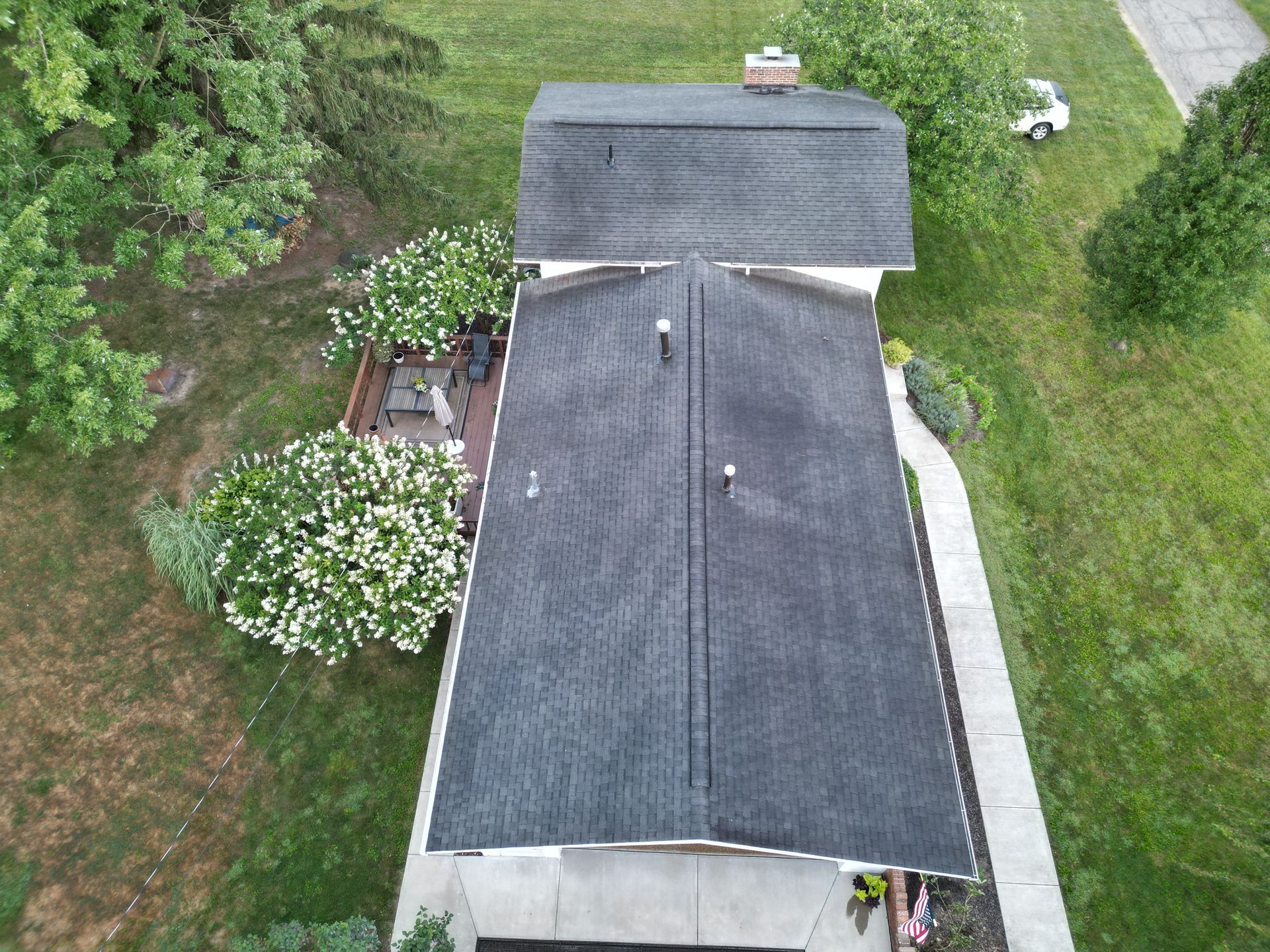An aerial view of a house with a roof that is covered in shingles.