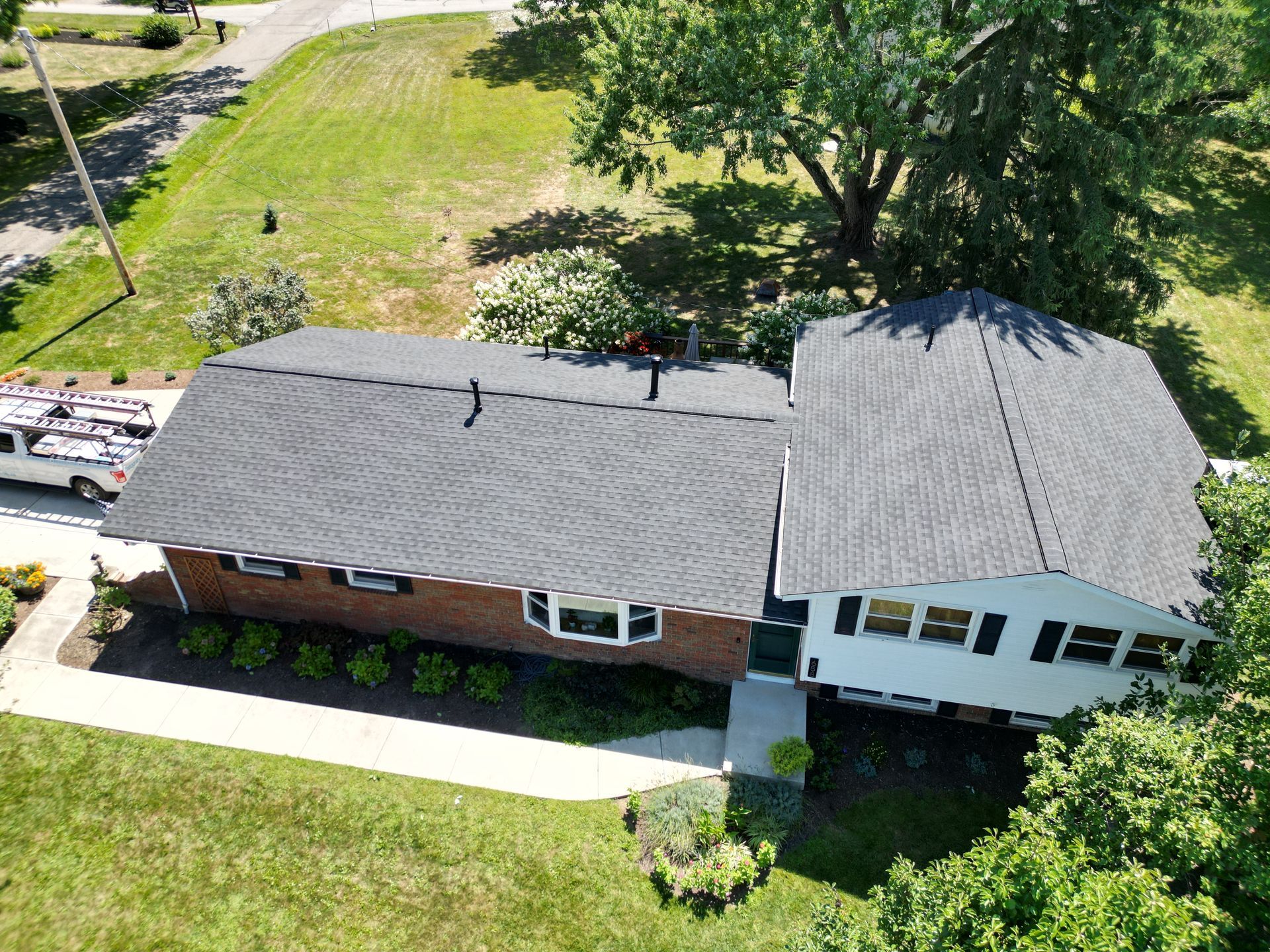 An aerial view of a house with a new roof.