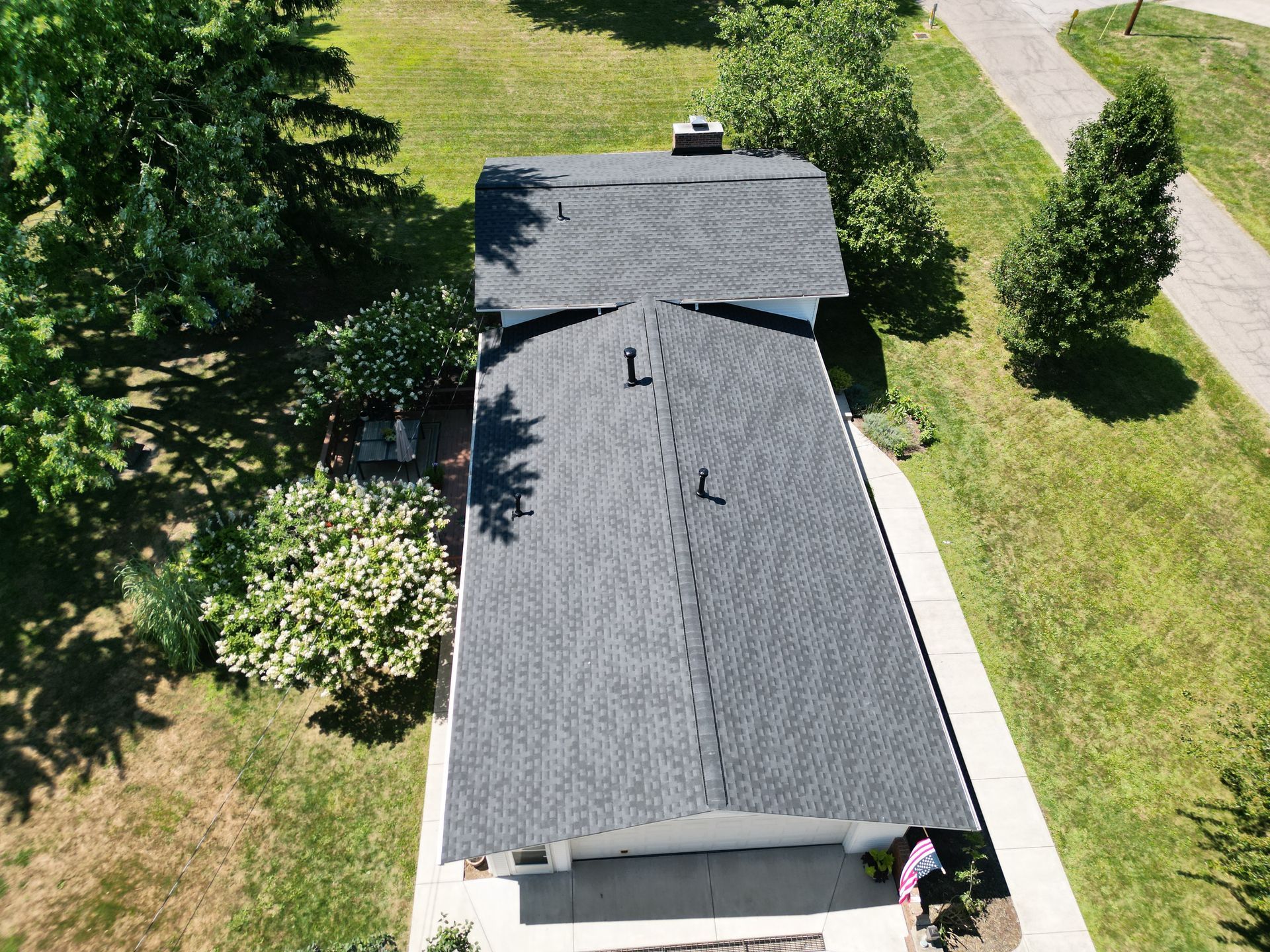 An aerial view of a house with a black roof