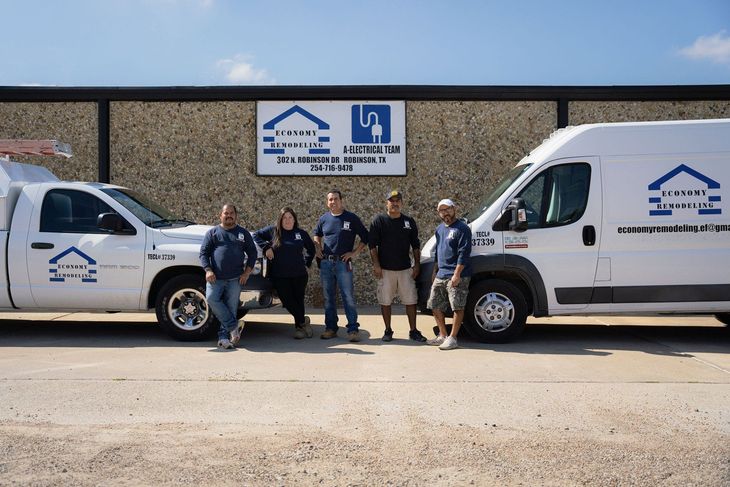 Economy Remodeling LLC's staff and vans