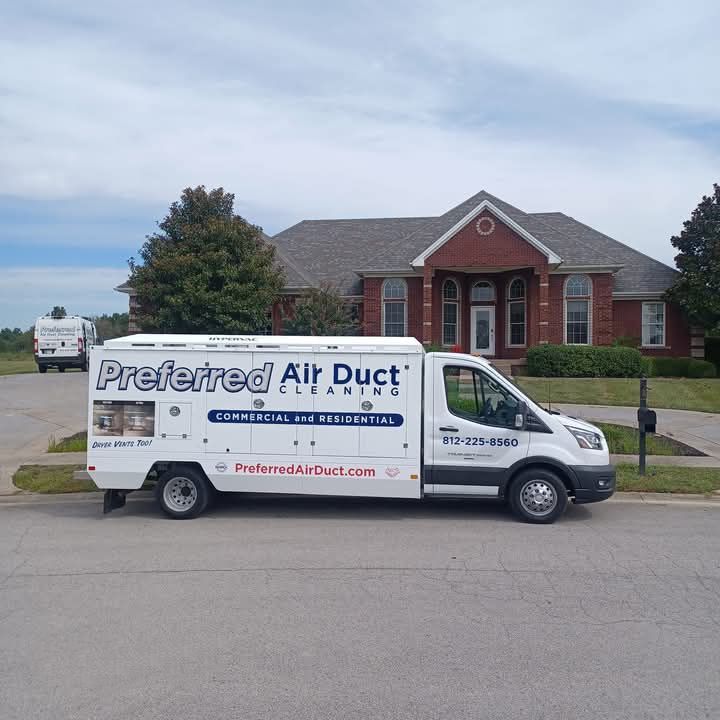 A preferred air duct van is parked in front of a brick house