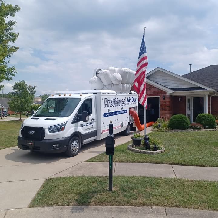 A white van is parked in front of a brick house.