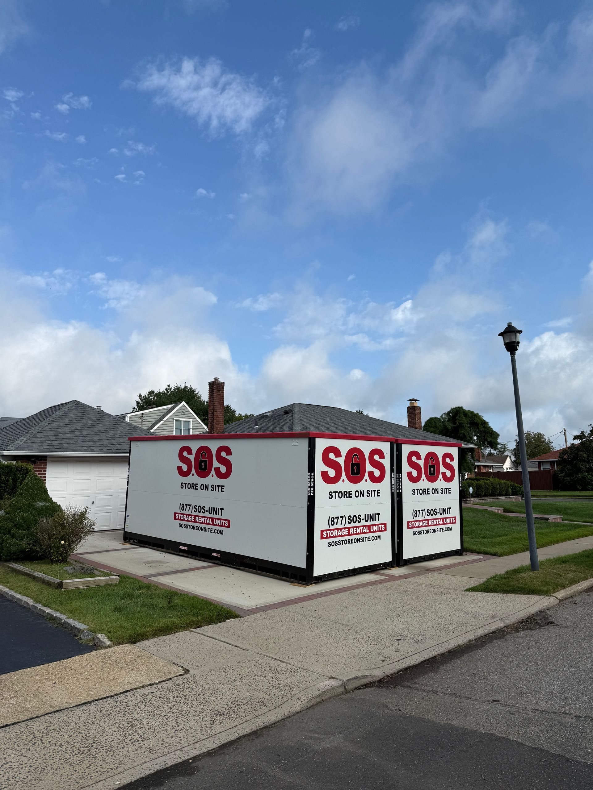 Three white storage containers with red 