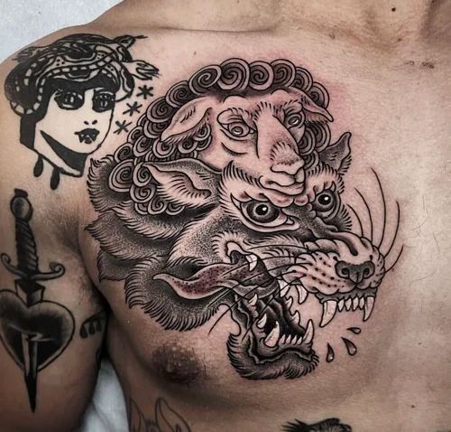 Black-and-gray chest tattoo of a snarling tiger with a lion and woman’s face above it