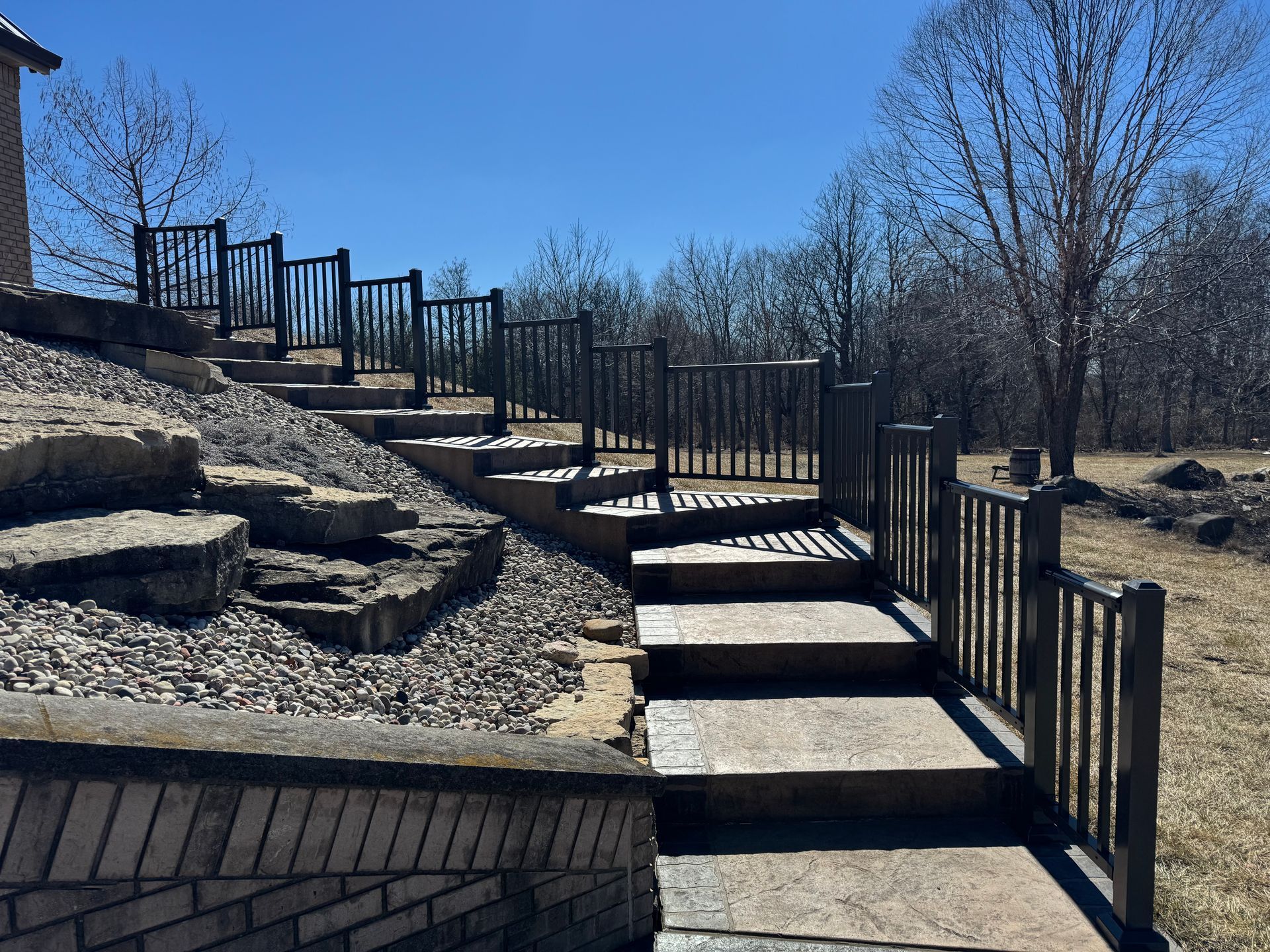 A set of stairs leading up to a deck with a railing.