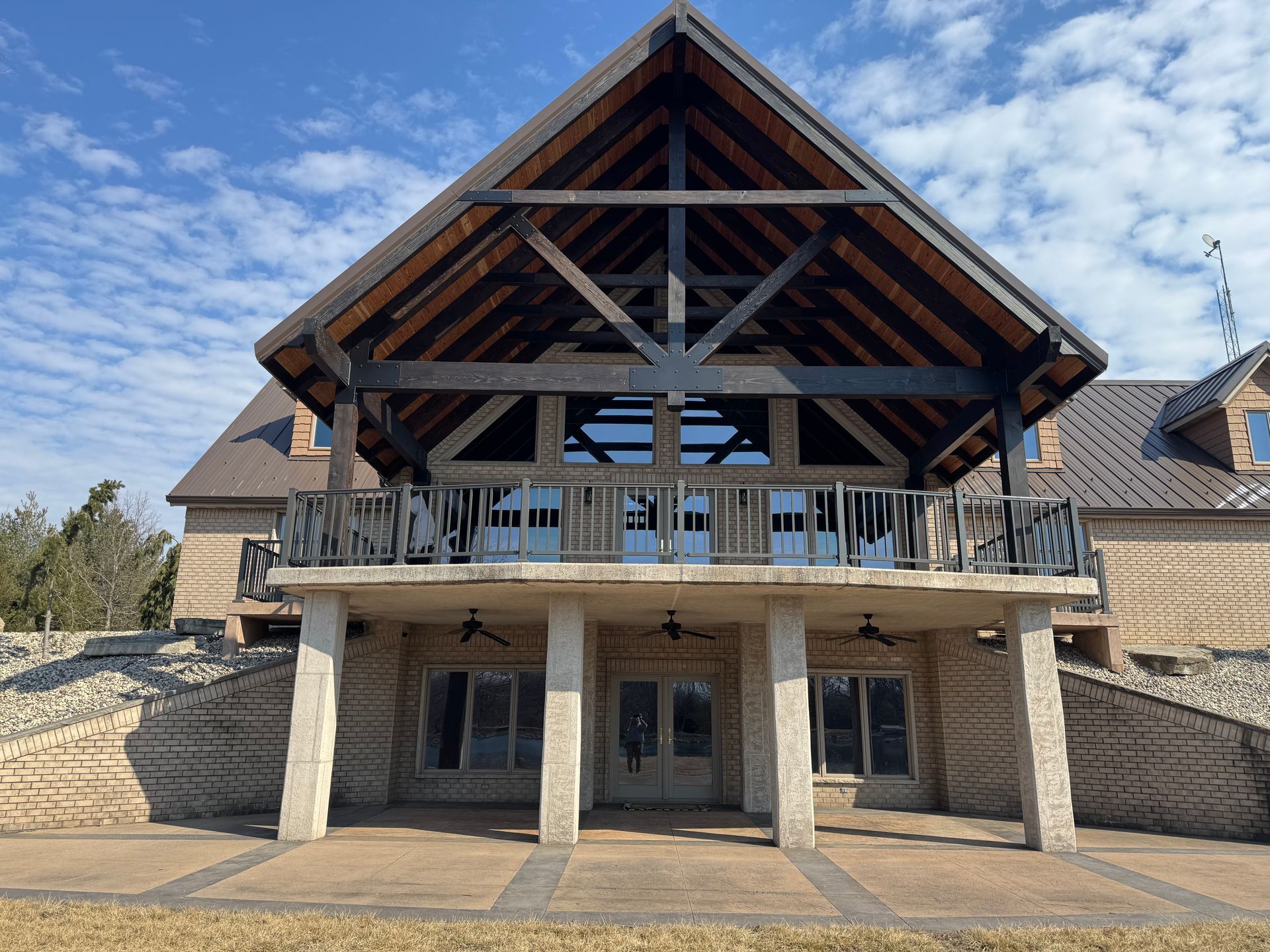 A large house with a wooden roof and a balcony.
