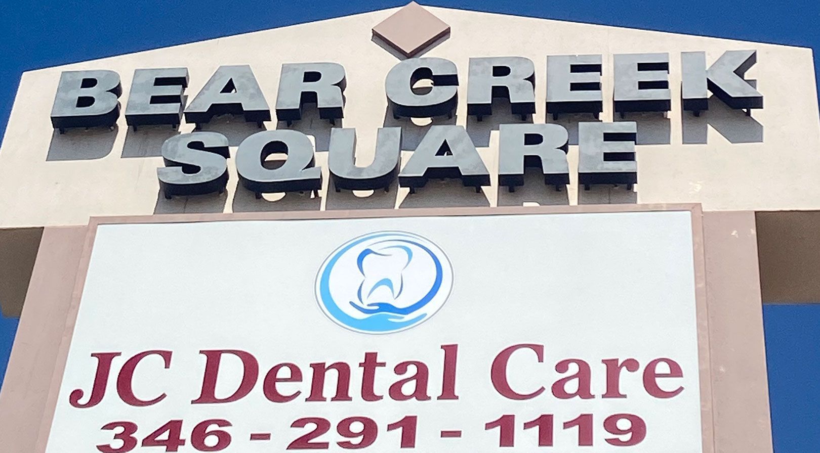 A sign for JC Dental Care at Bear Creek Square