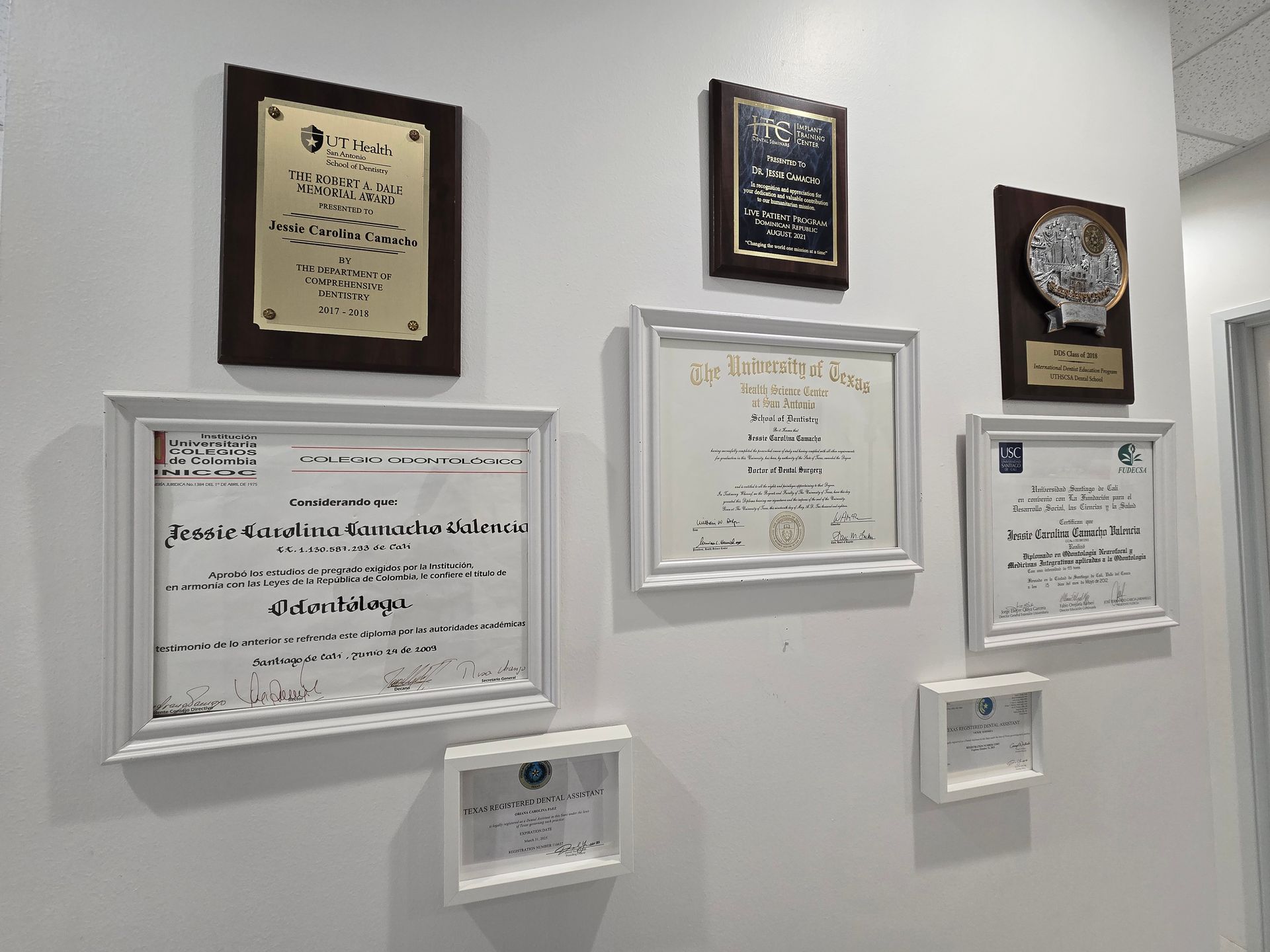 A wall with a bunch of certificates on it