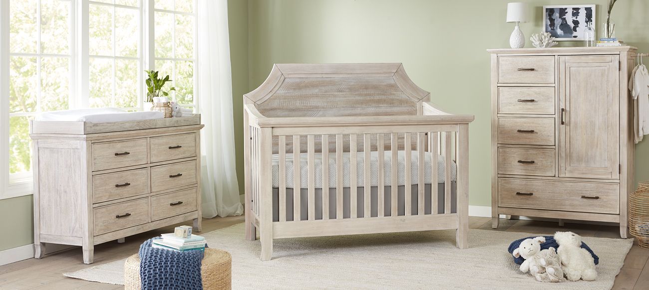 a baby room with a Remi crib, dresser, and changing table.