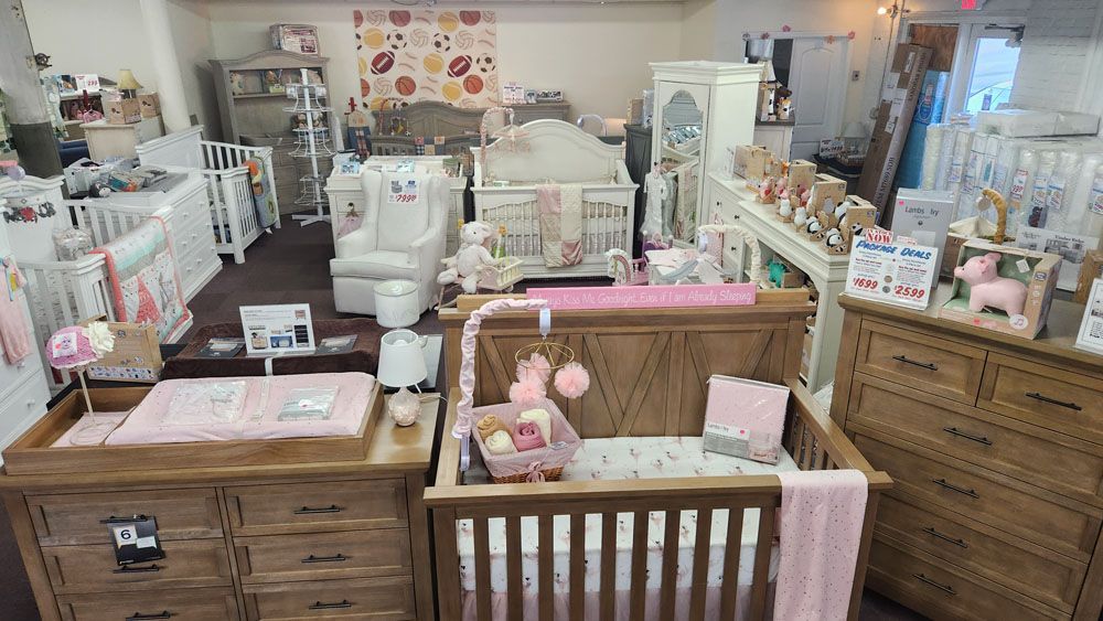A baby room with a crib, dresser, and changing table