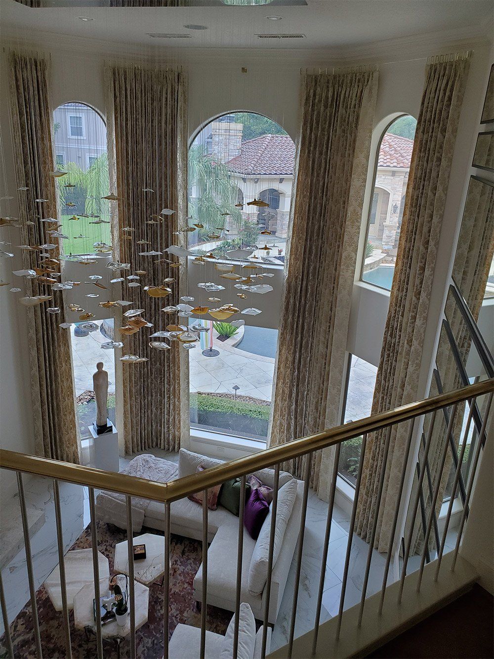 A view of a living room from the top of a staircase.