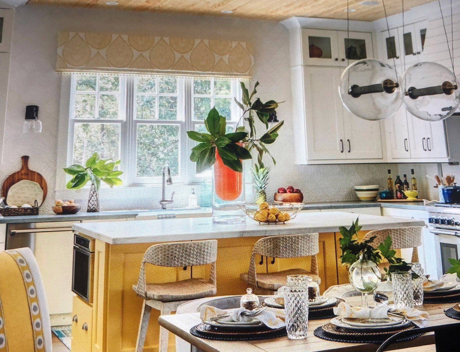 A kitchen with a table and chairs and a sink