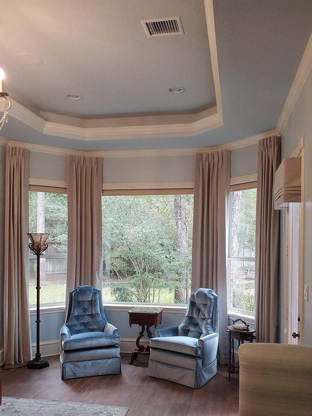 A living room with a lot of furniture and a large window.