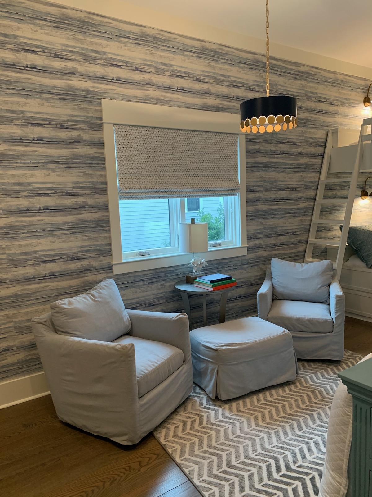 There are two chairs and an ottoman in the room.