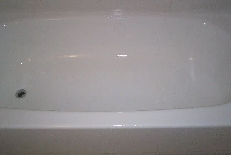 a white bathtub with a drain on the side of it