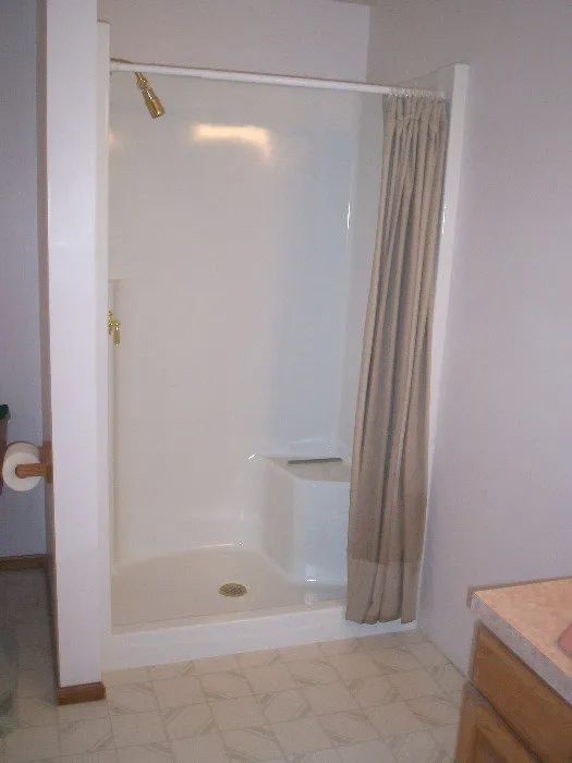 a bathroom with a shower and a toilet