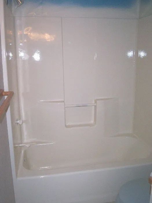 a bathroom with a bathtub and shower stall