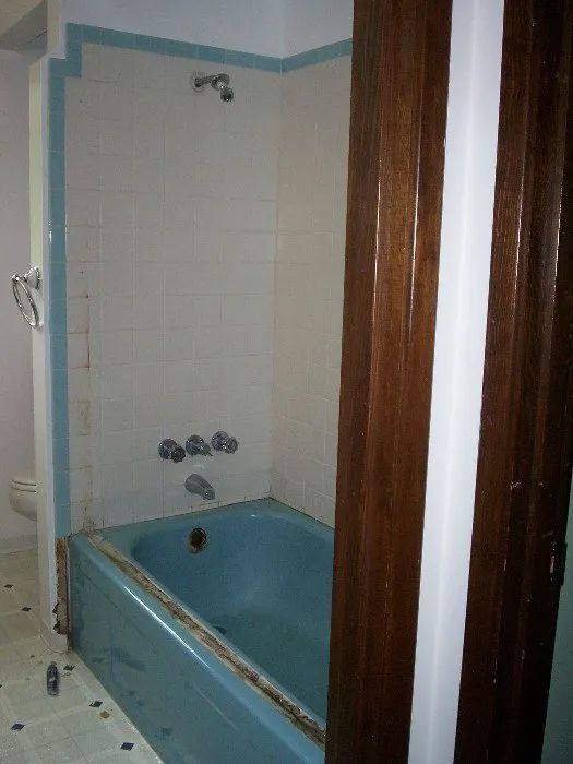 a bathroom with a blue bathtub and a shower