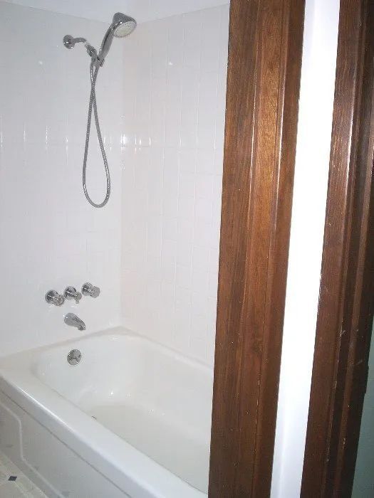 a bathtub with a shower head attached to it