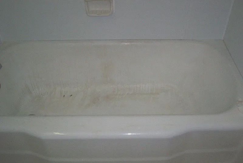 a white bathtub is sitting in a bathroom next to a white wall