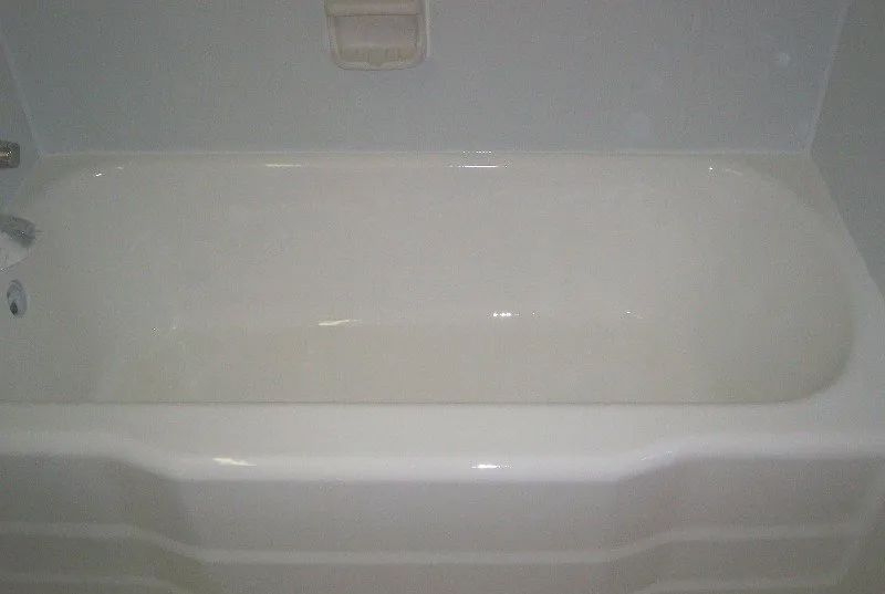 a white bathtub is sitting in a bathroom next to a white wall