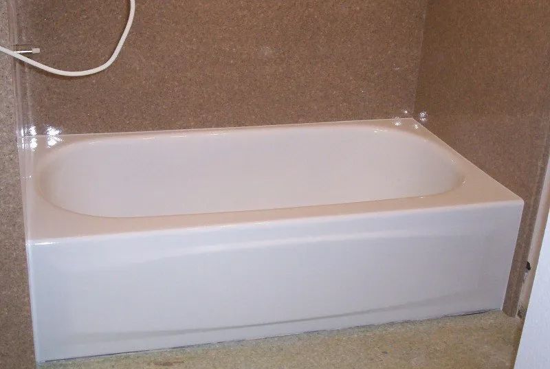 a white bathtub is sitting in a bathroom next to a shower