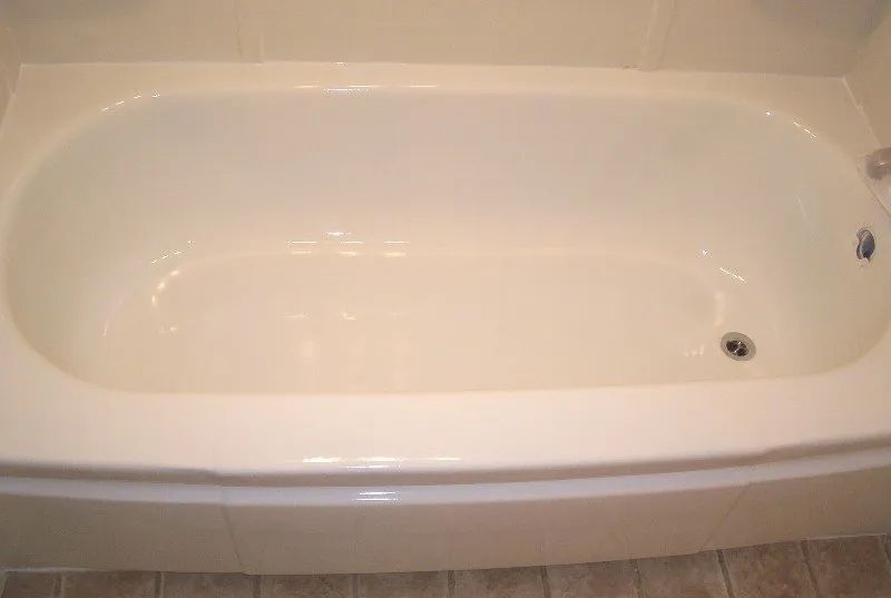 a white bathtub is sitting on a tiled floor in a bathroom