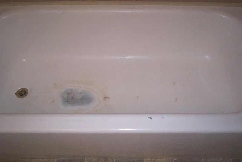 a white bathtub with a hole in the middle of it