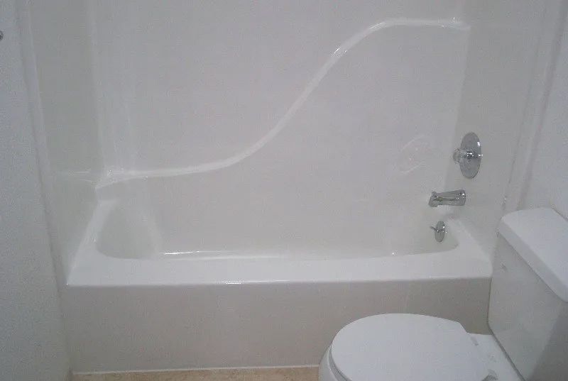 a bathroom with a bathtub and a toilet