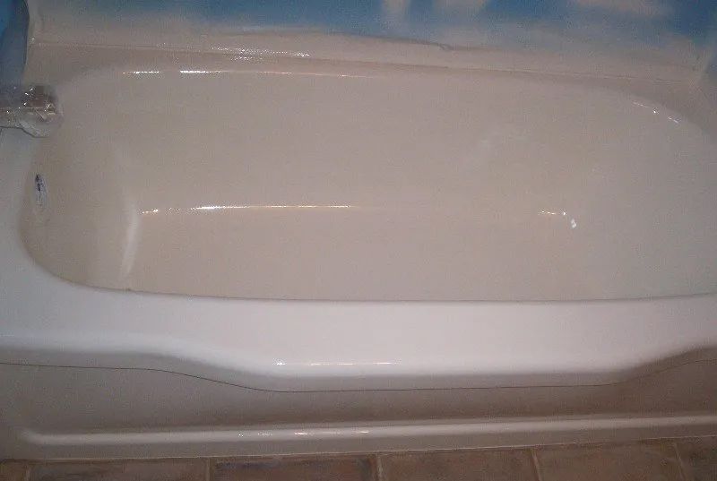 a white bathtub is sitting on a tiled floor in a bathroom