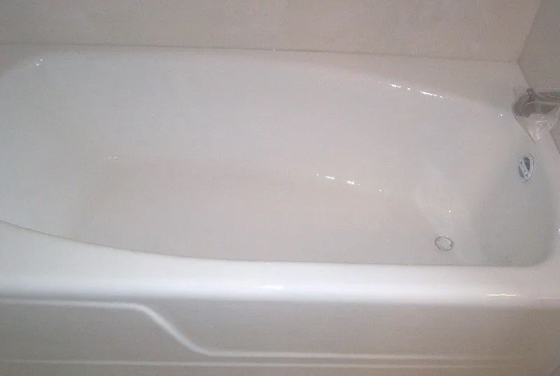 a white bathtub is sitting in a bathroom next to a wall