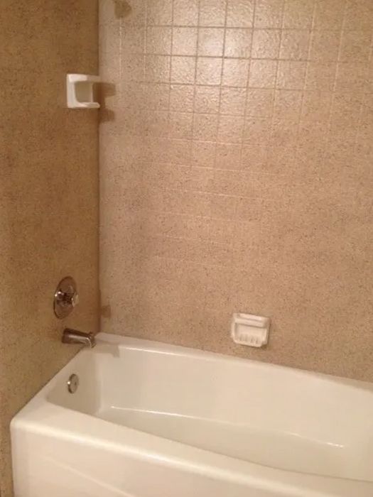 a bathtub is sitting in a bathroom next to a shower
