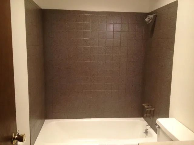 a bathroom with a bathtub and a toilet