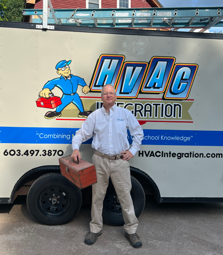 Man standing beside an HVAC service truck with a large HVAC Integration logo and cartoon technician graphic