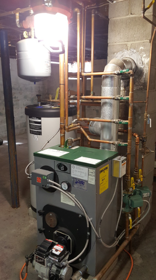 Residential boiler and plumbing system in a basement, with copper pipes, white tank, and green furnace unit.
