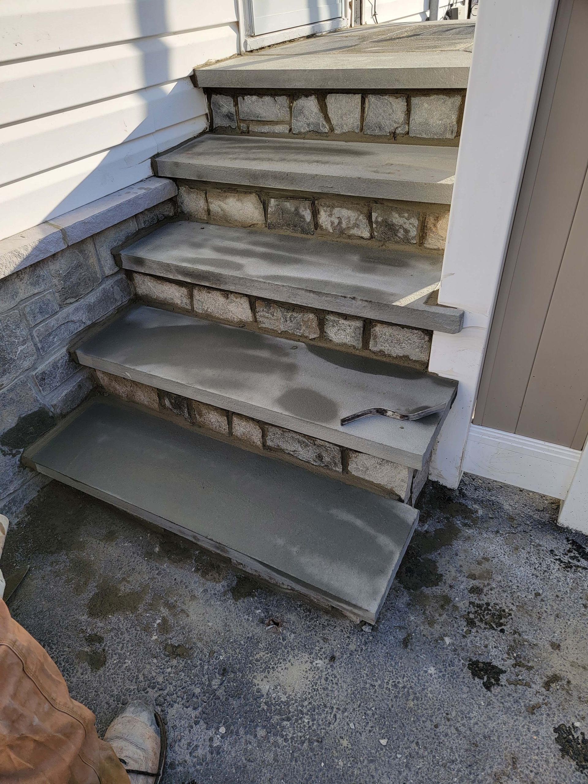 a set of concrete steps leading up to a house .