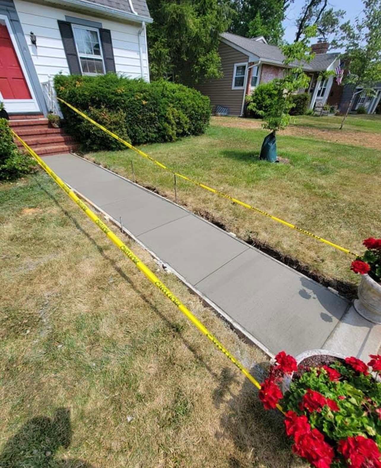 a concrete walkway is being built in front of a house .