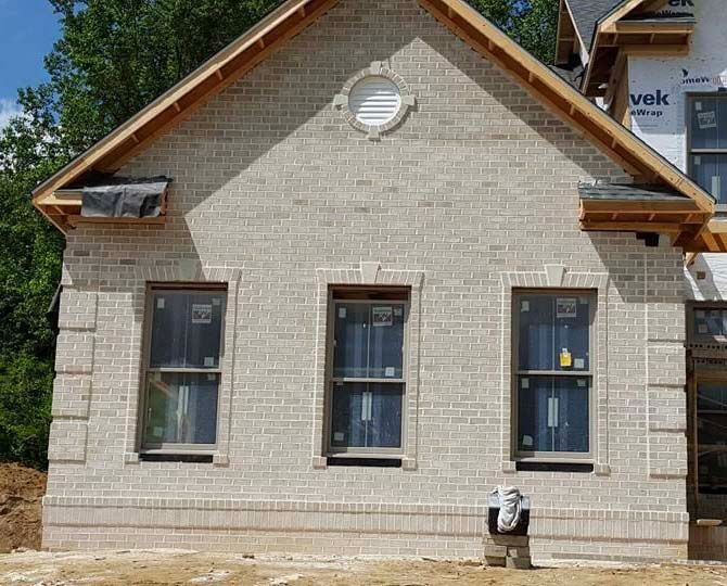 a house that is being built with a lot of windows