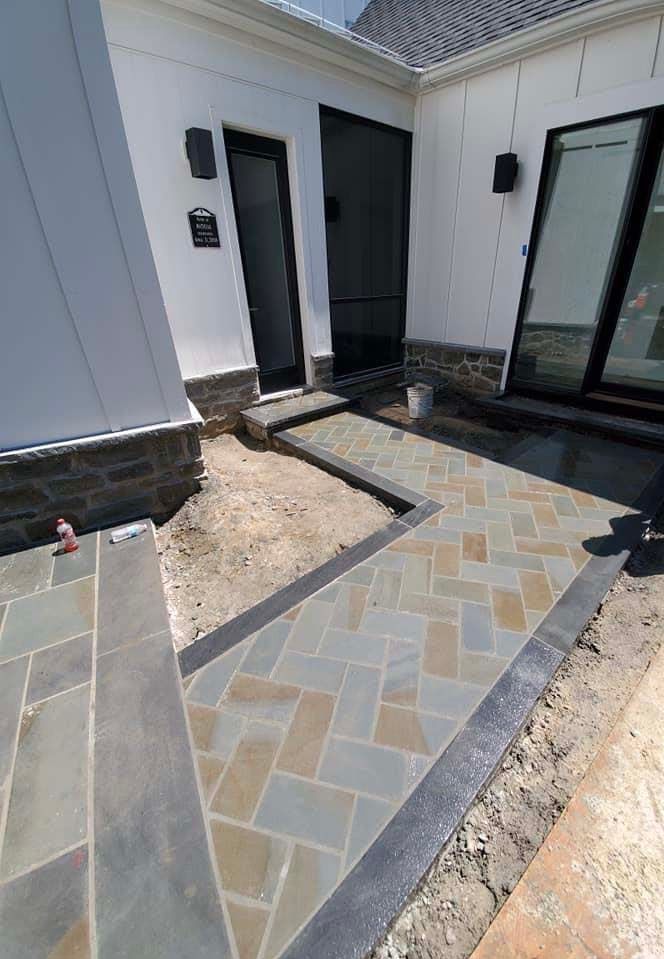 a stone walkway is being built in front of a house .