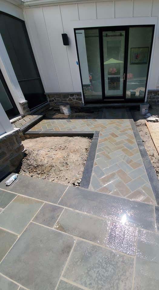 a stone walkway is being built in front of a house .