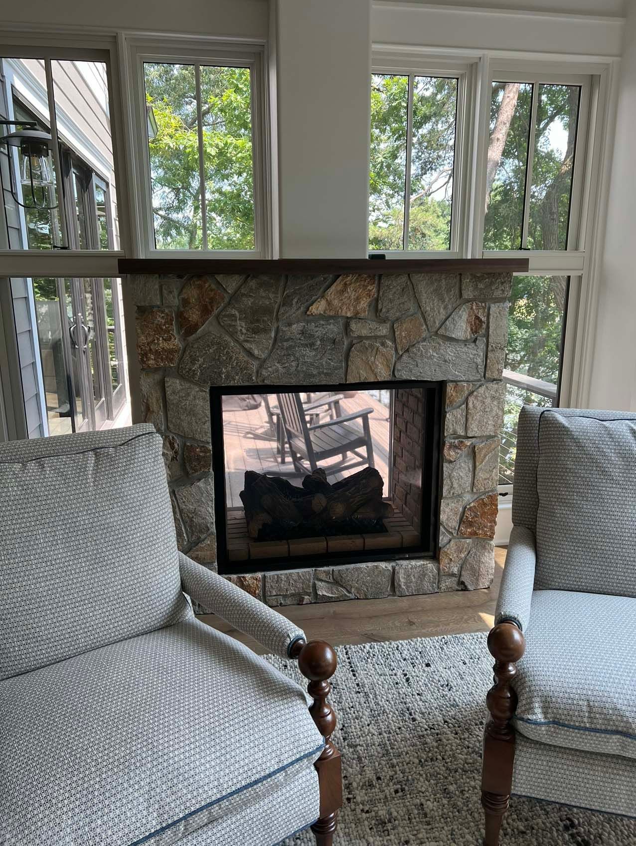 a living room with two chairs and a fireplace .