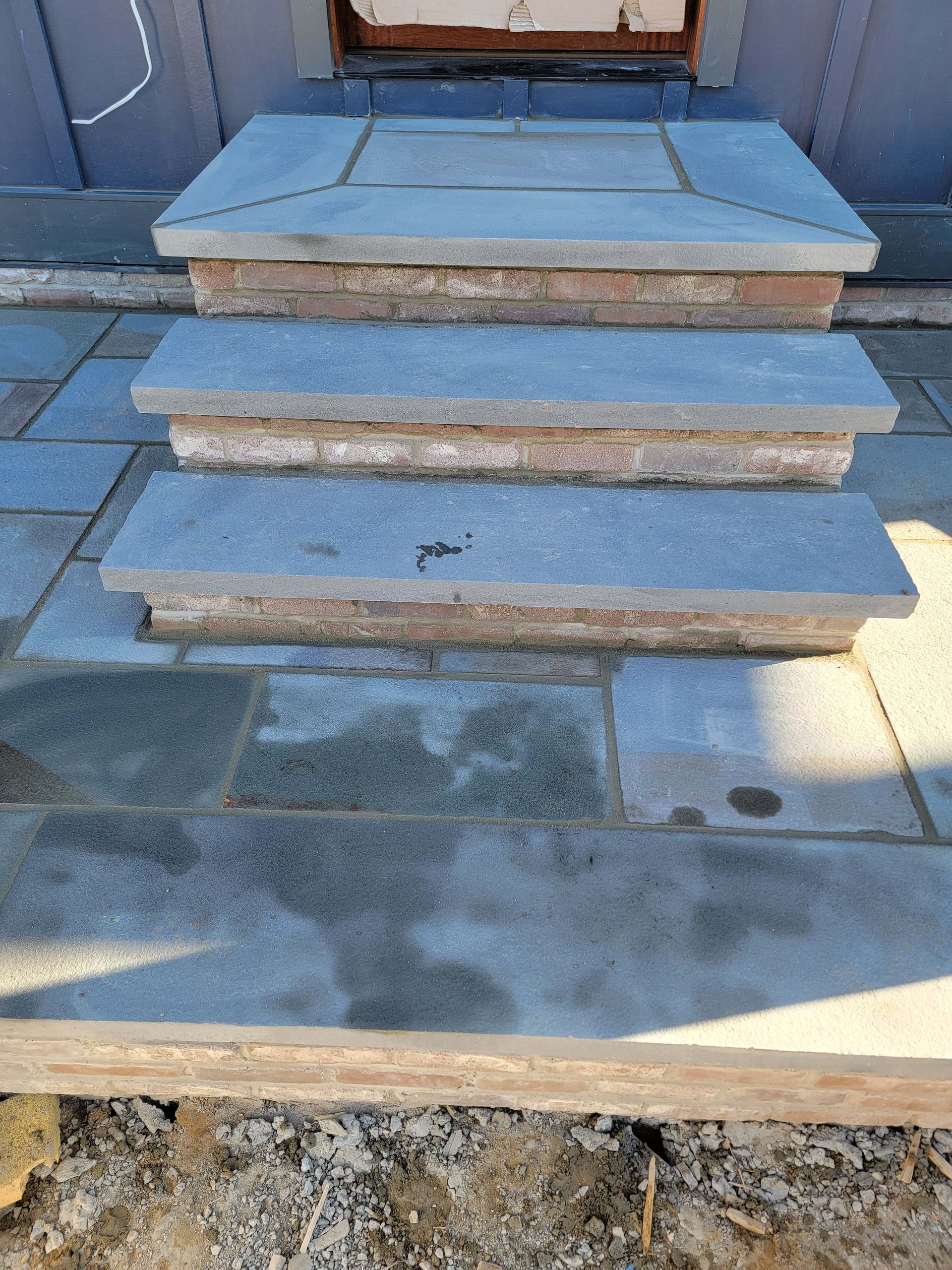 a row of stone steps leading up to a doorway .