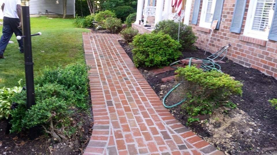 a brick walkway in front of a house .