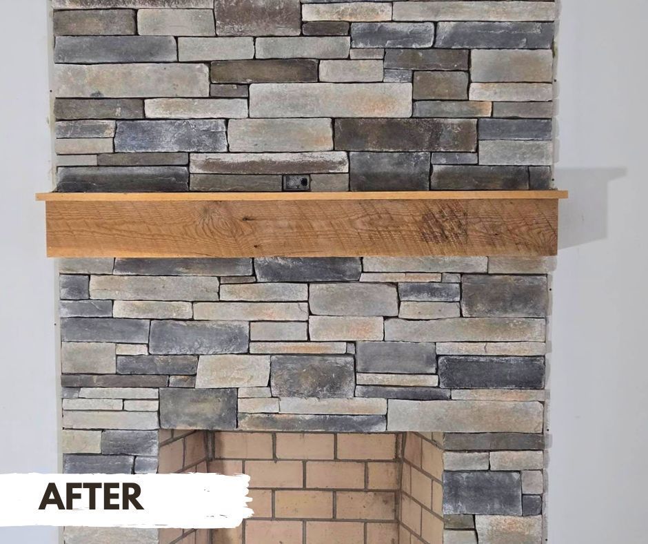 A fireplace with stacked stone facing and a rustic wooden mantel;