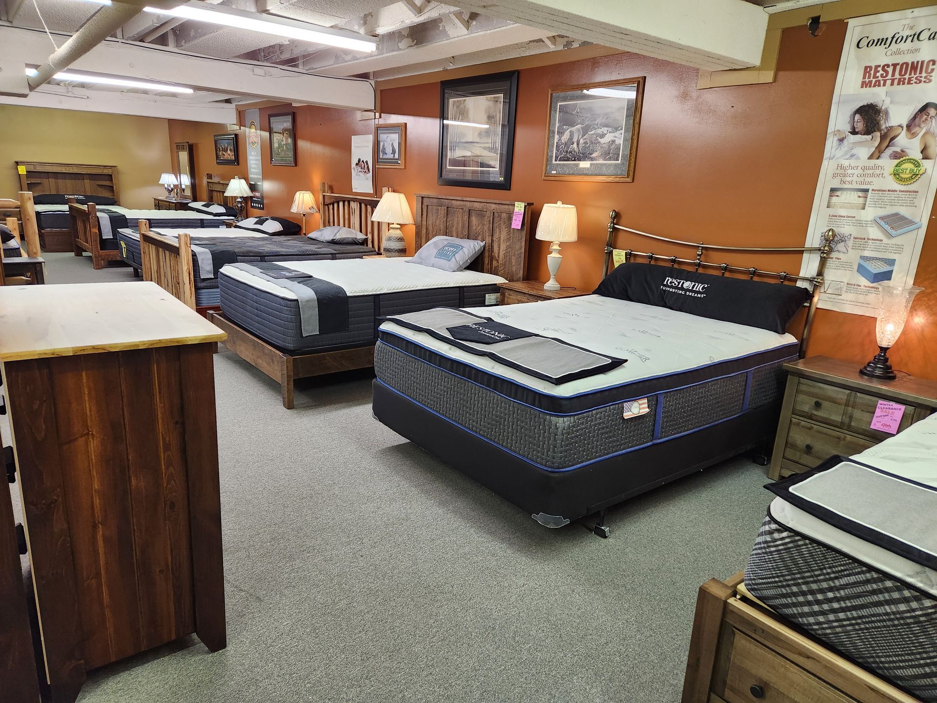 A mattress store filled with lots of beds and mattresses.