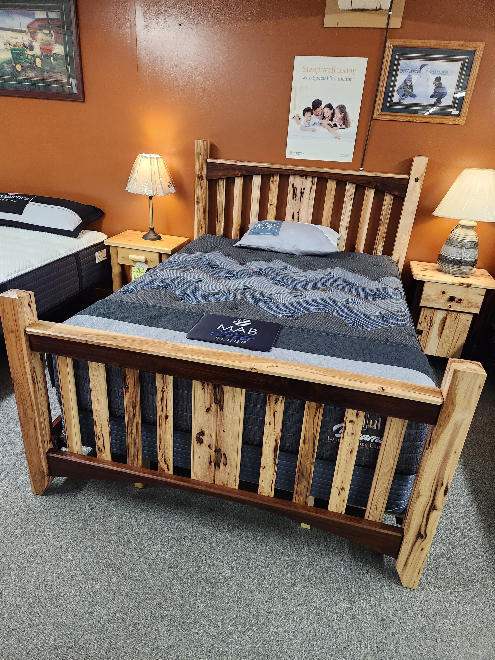 A wooden bed is sitting in a bedroom next to a mattress.