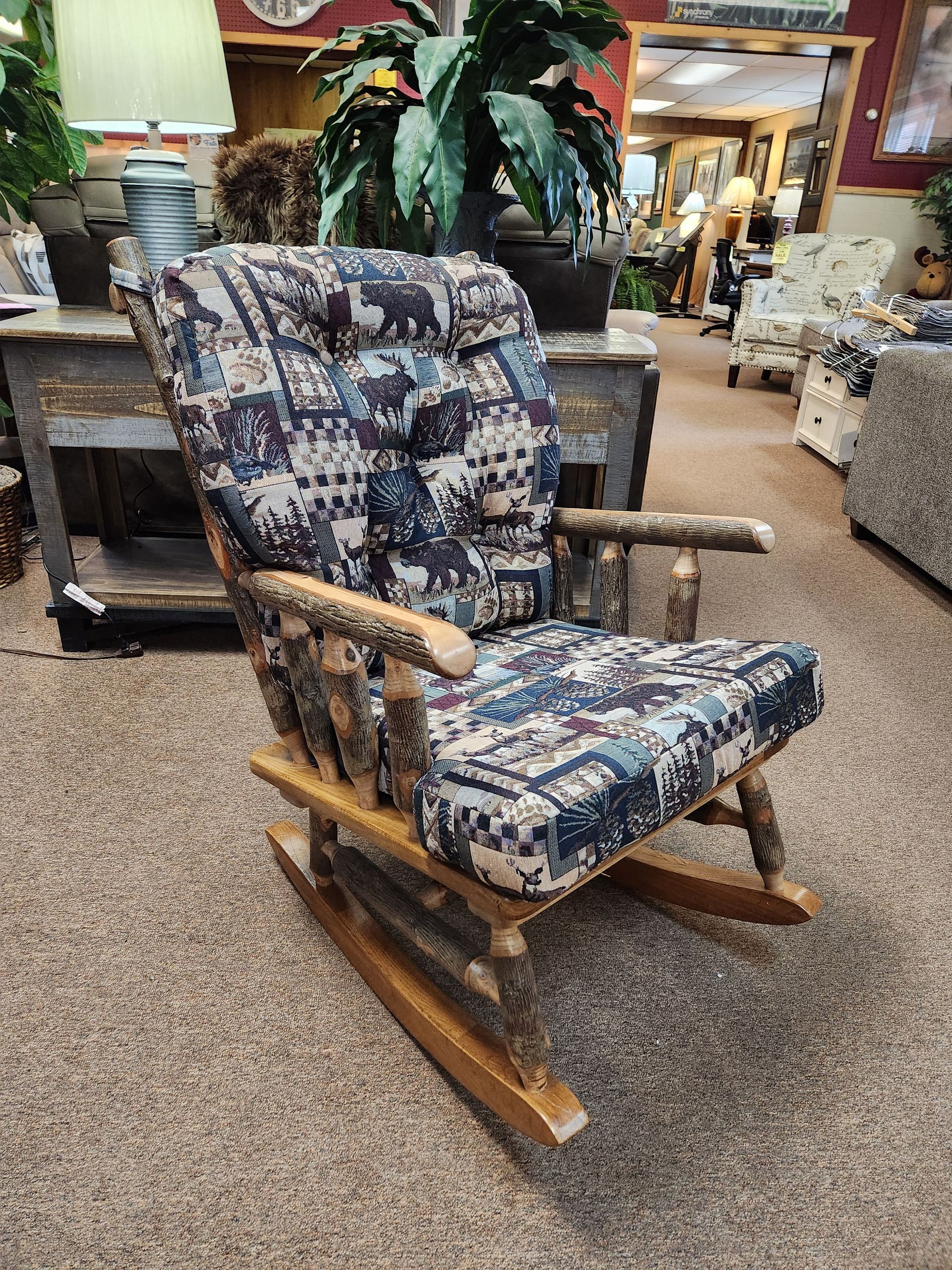 A rocking chair is sitting on the floor in a living room.