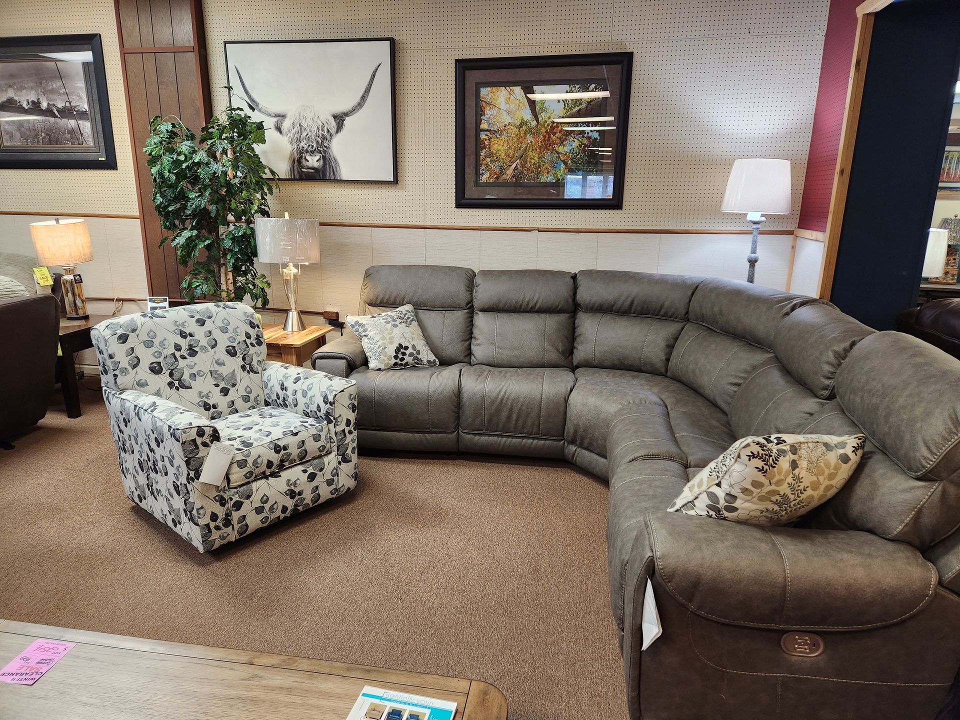 A living room with a sectional couch and a chair